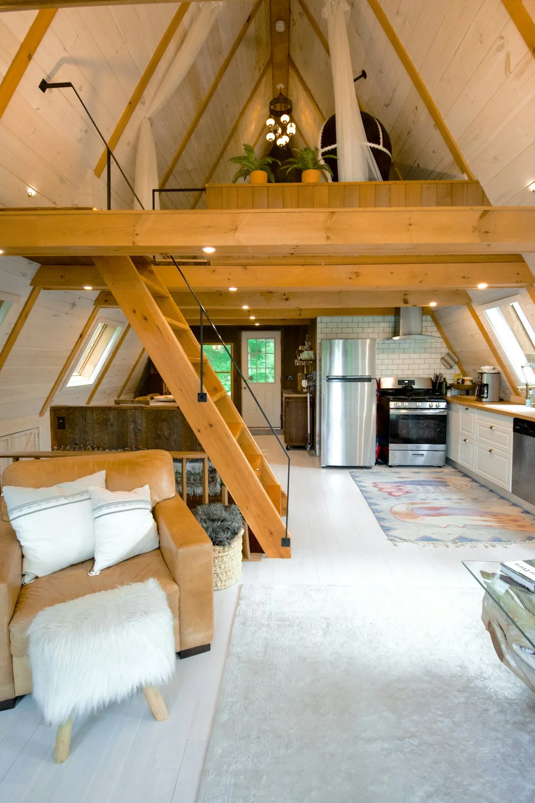 Bright timber-framed A-frame interior with natural wood finishes