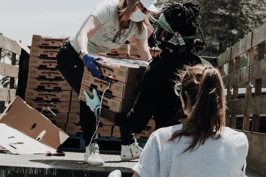 Volunteers sorting donated goods into stacked boxes
