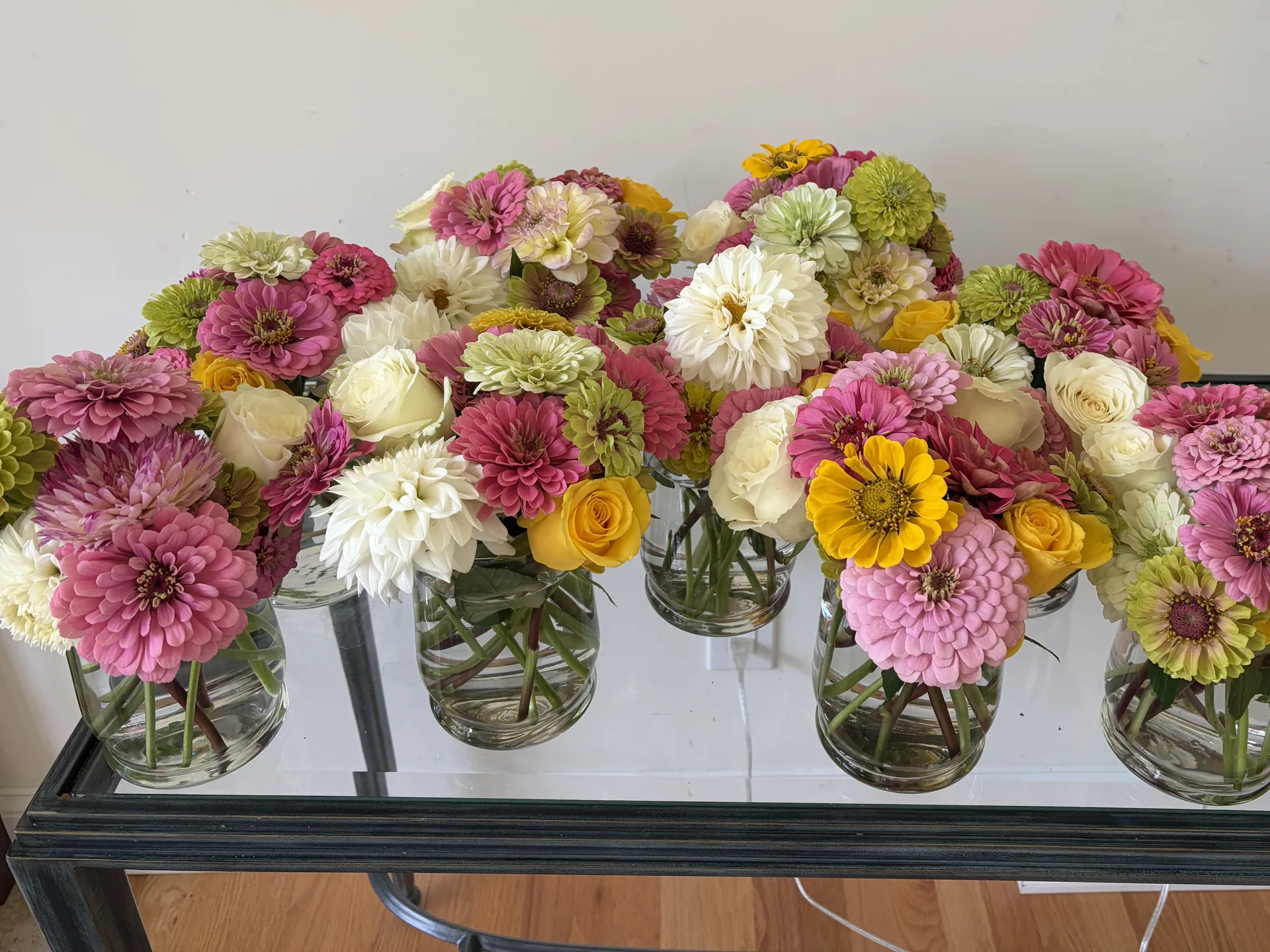 Finished jarred bouquets lined up on a table at the end of a session