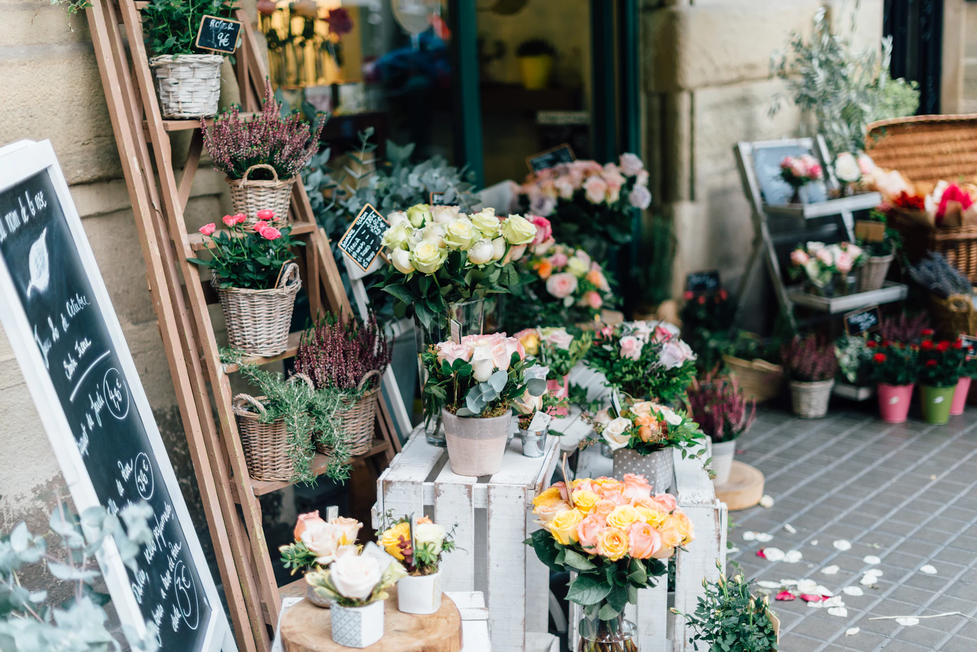 A vintage truck loaded with buckets of flowers