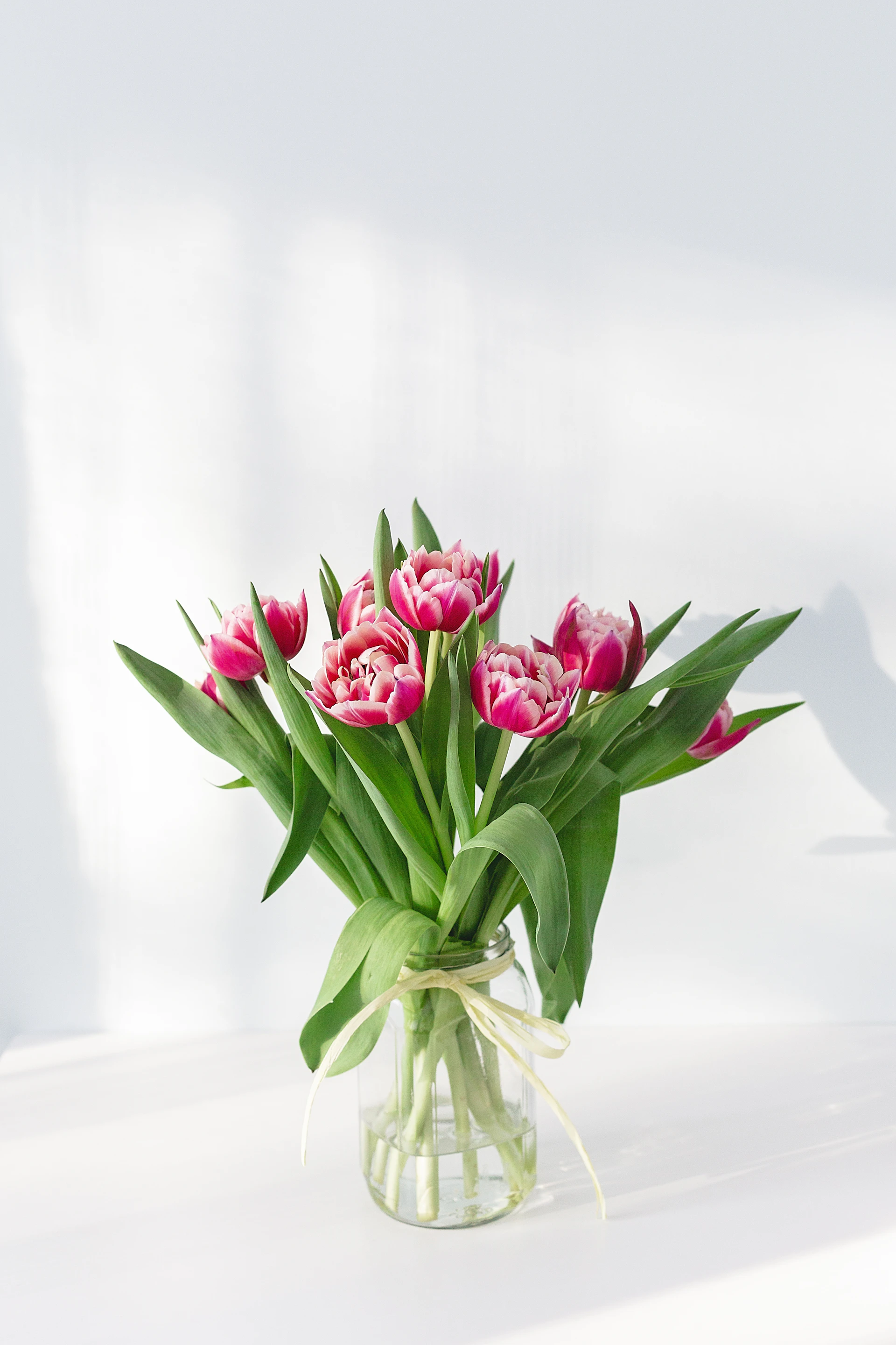 The Cottage wrapped bouquet — soft blush dahlias, garden roses, and trailing greenery
