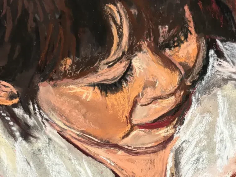 Close-up of the woman's face and dark hair against white cloth