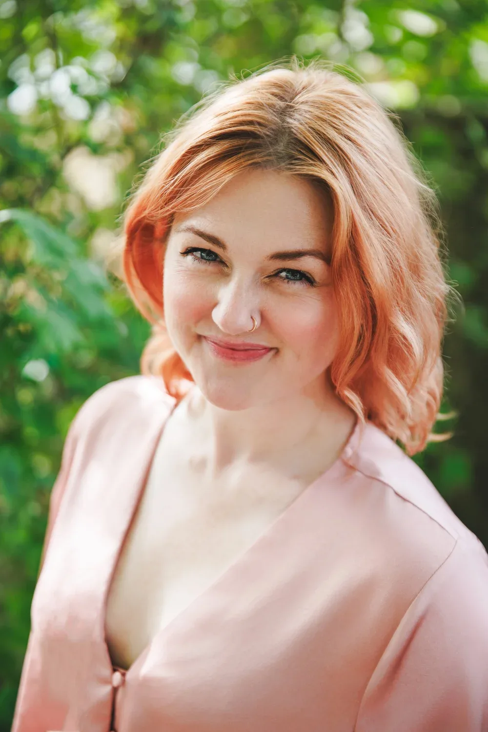 Portrait of Whitney Page outdoors in front of green foliage