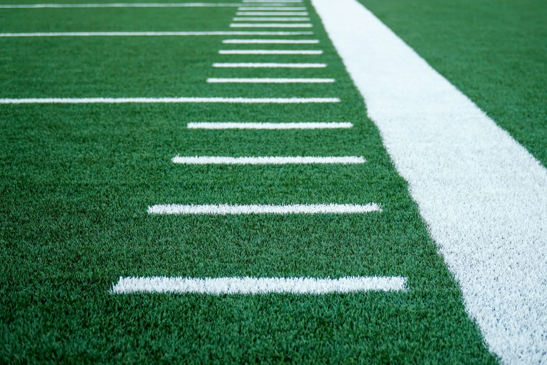 Striped athletic field turf with yard markings