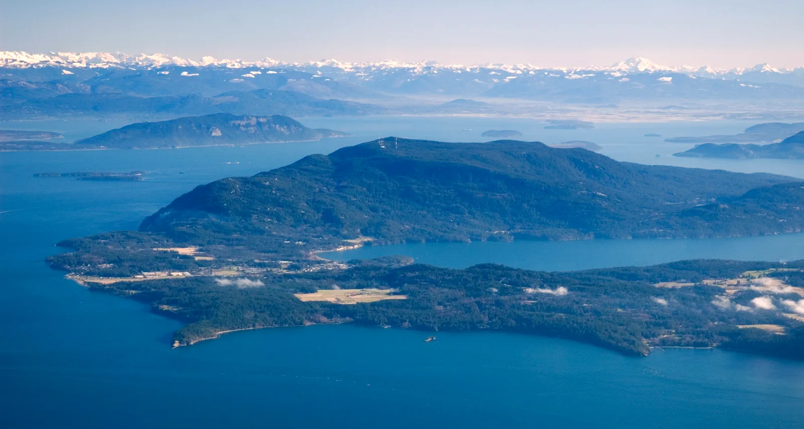 Aerial view of Orcas Island and the San Juan Islands, with the Cascade Range on the horizon