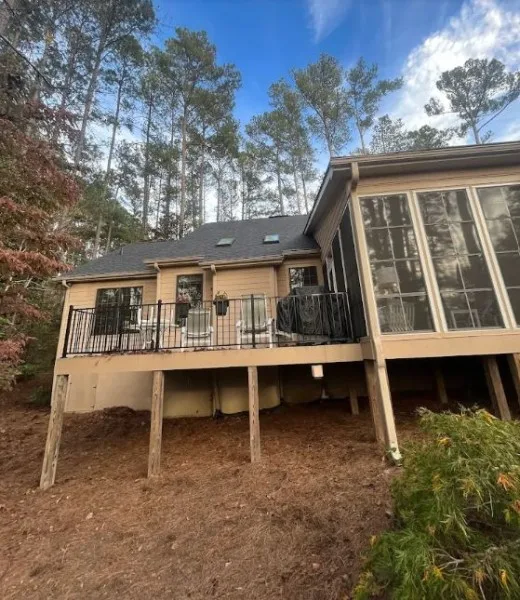 Finished shingle roof on a wooded home with a screened porch