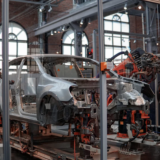 Robotic arms assembling a car body on a factory line