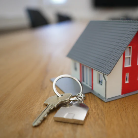 House keys beside a model home on a desk