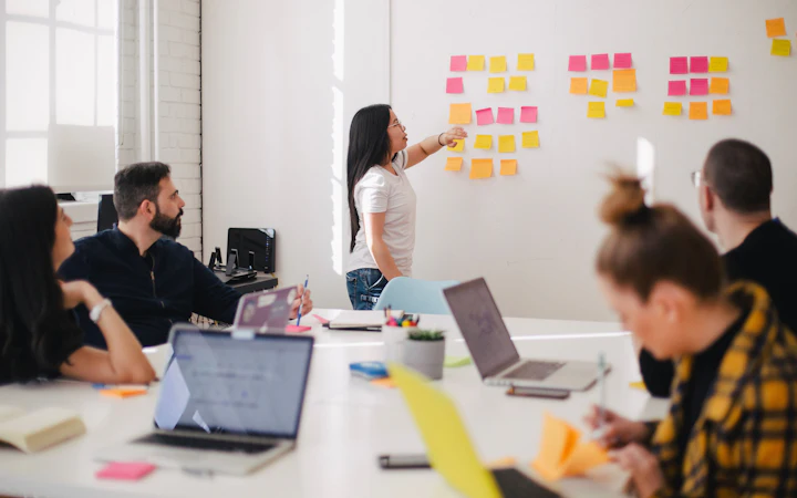A planning workshop with priorities mapped out in sticky notes on a whiteboard