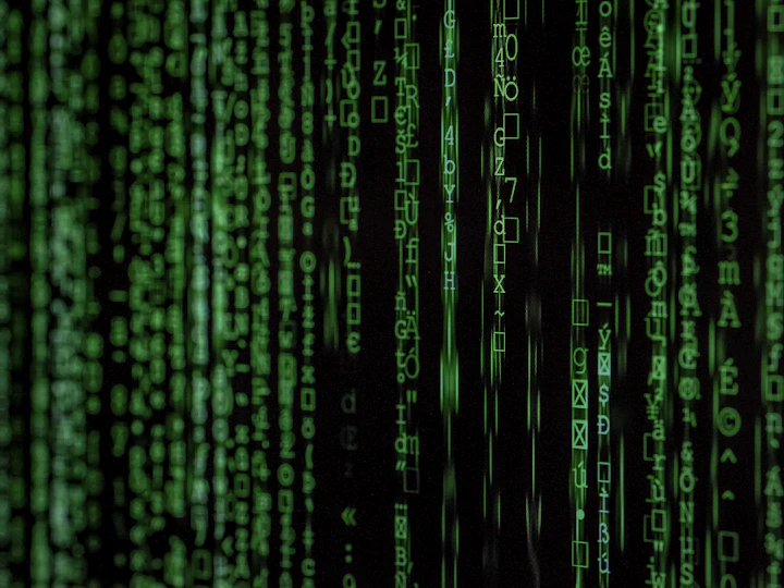 Streams of green code running down a dark screen