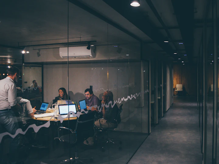 A team working late in a glass-walled office