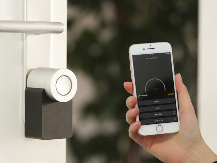 A smart door lock being unlocked from a phone app