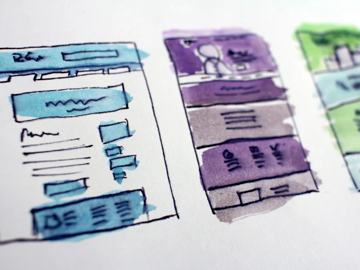 Website page layouts sketched by hand on paper