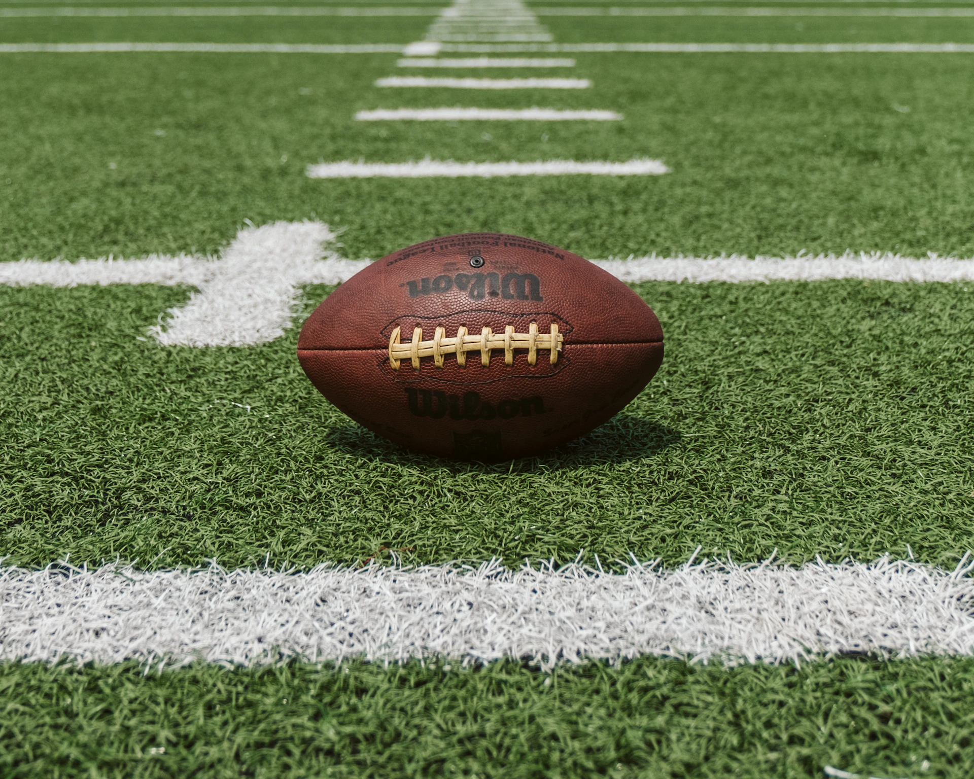 Football on the field under the lights