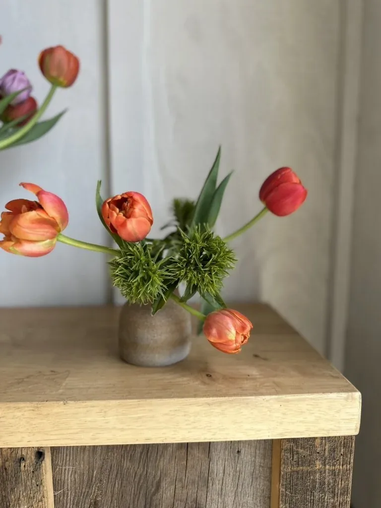 A bucket of bud-vase-ready blooms for a restaurant house account