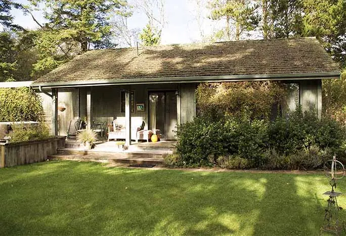 Water's Edge Cottage with its covered porch and lawn