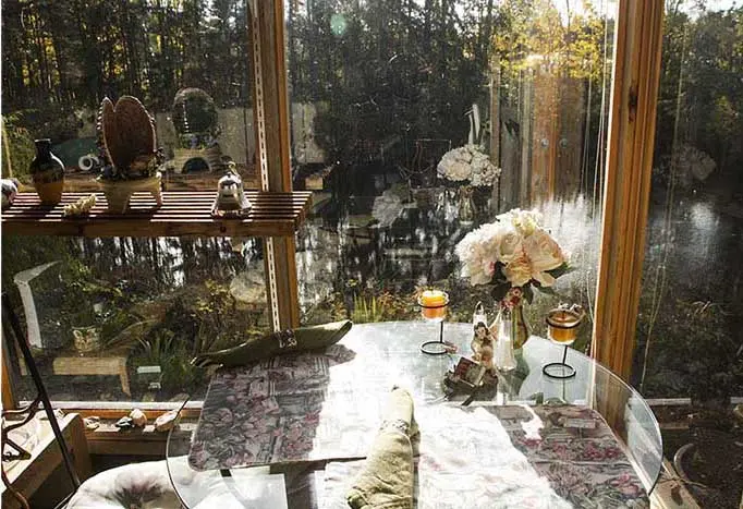 Breakfast table in the Green House Suite sunroom overlooking the pond