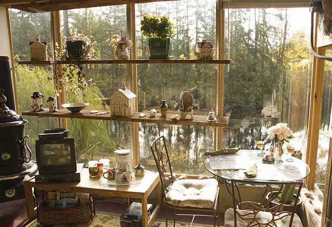Glassed-in sitting area of the Green House Suite, with the pond beyond