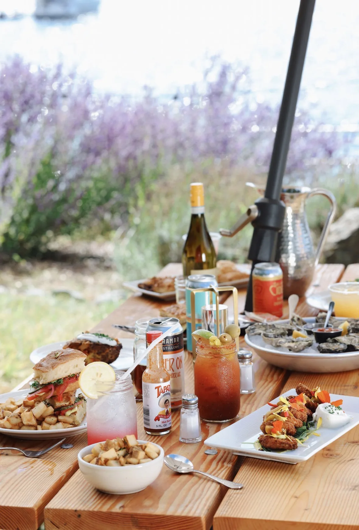 Outdoor dining scene with wine, local dishes, and lavender fields at Blackfish Café