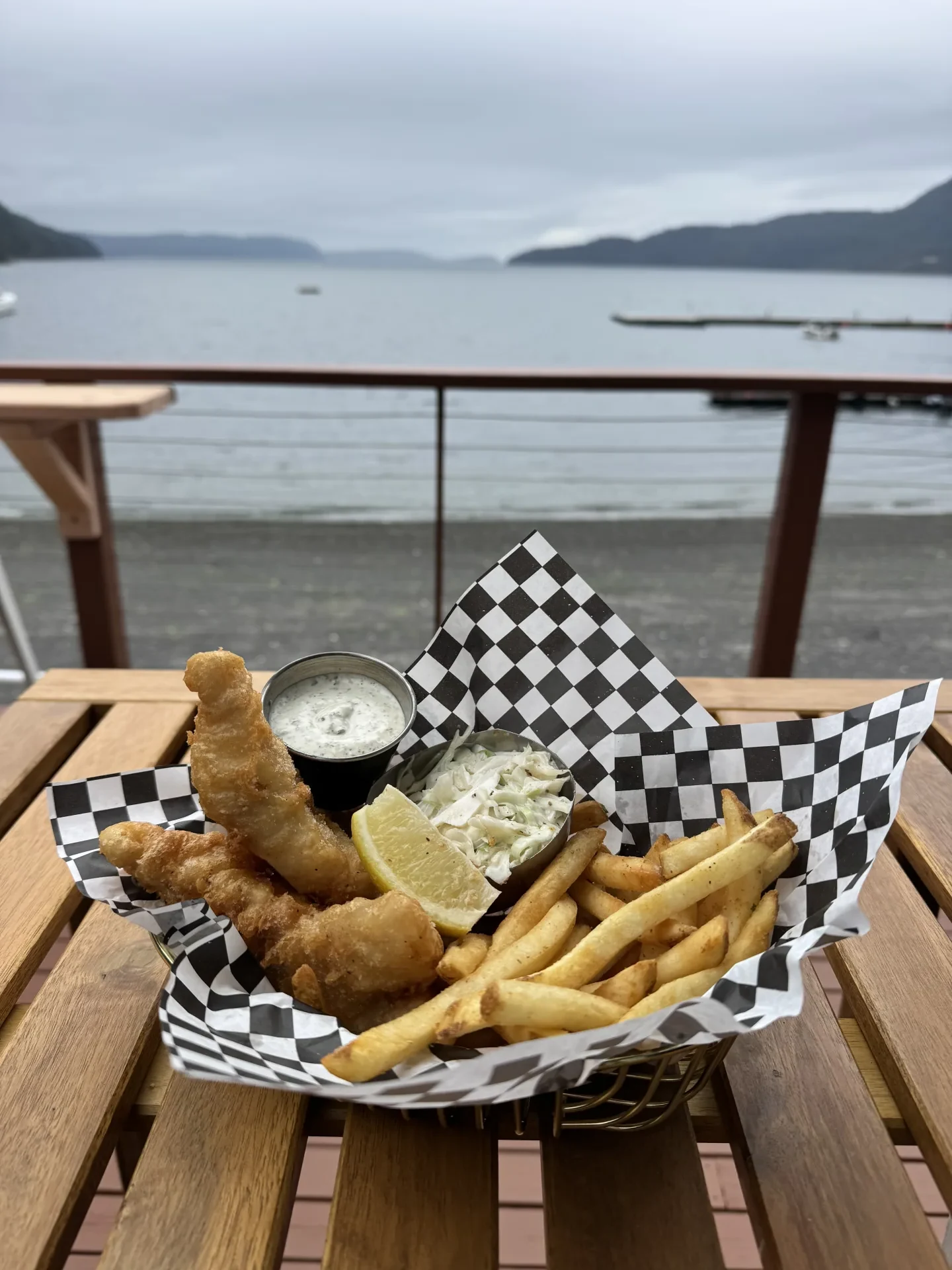 Beer-battered fish and chips with slaw and tartar in a basket